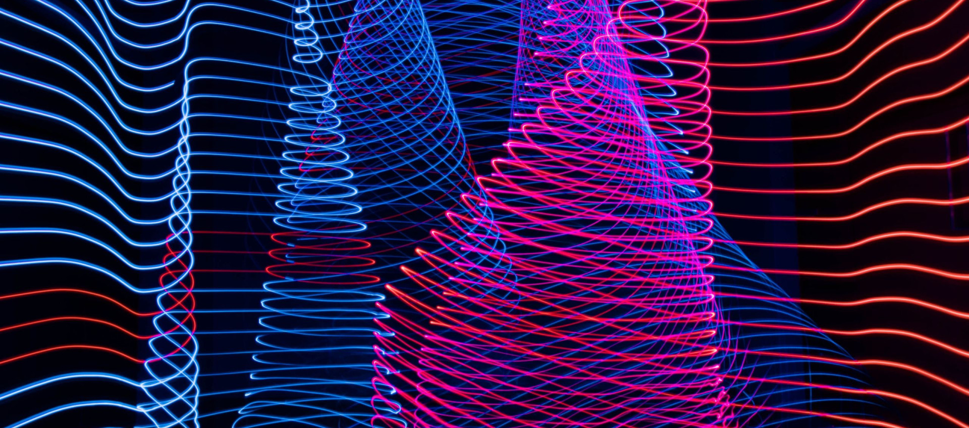 A striking light painting showcasing a blend of blue and red colors on a contrasting black background.