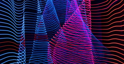 A striking light painting showcasing a blend of blue and red colors on a contrasting black background.