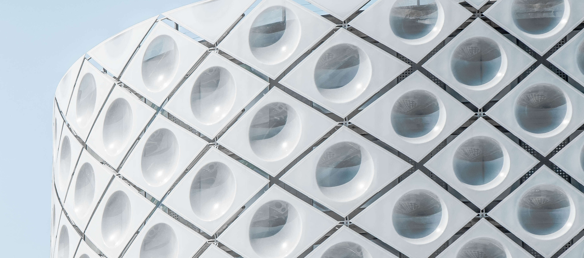 outer white building with unusual design with a blue sky background