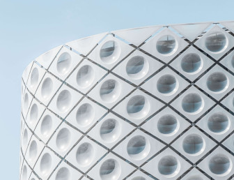 outer white building with unusual design with a blue sky background