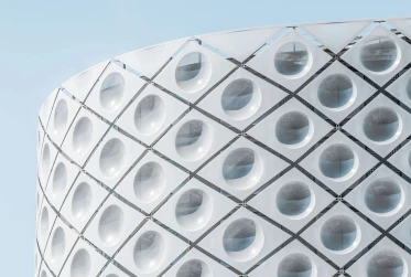 outer white building with unusual design with a blue sky background