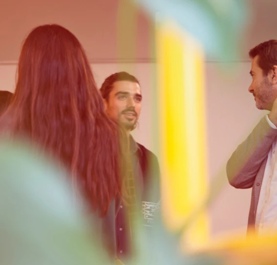 Two individuals engaged in a brief conversation in an office setting.