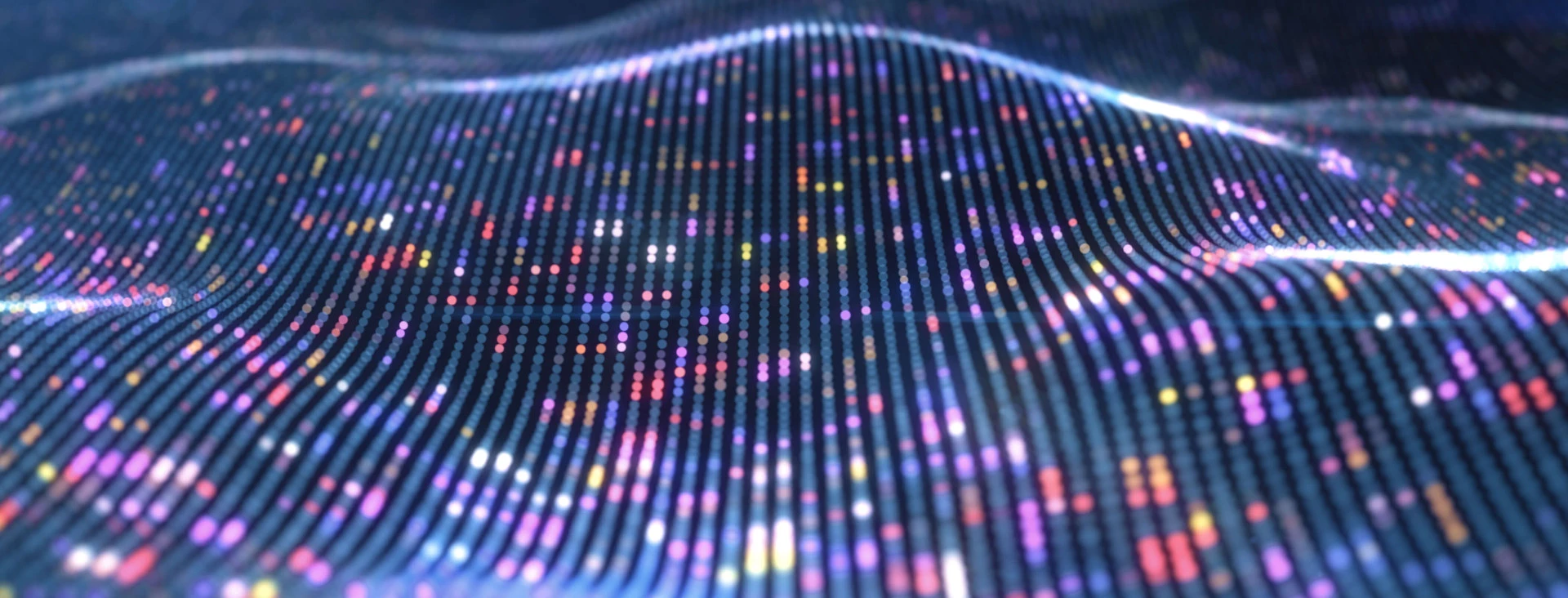 digital pattern of dots in a wave shape in various colours with a navy blue background