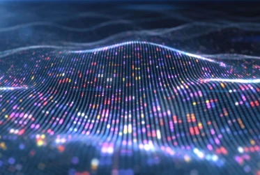 digital pattern of dots in a wave shape in various colours with a navy blue background