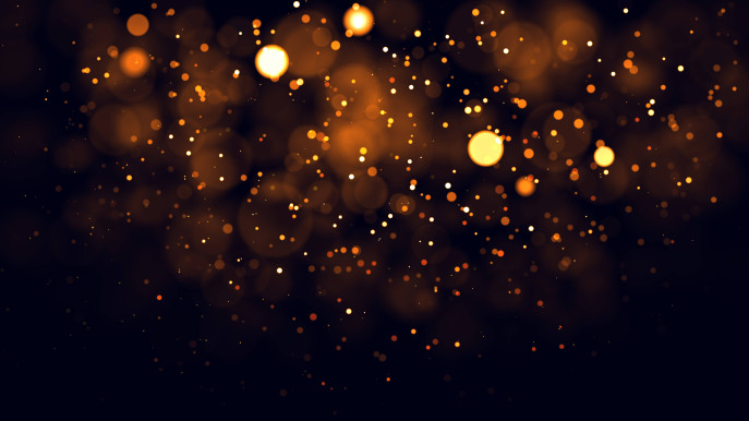 pattern of floating small and large lights in yellow and orange on black background