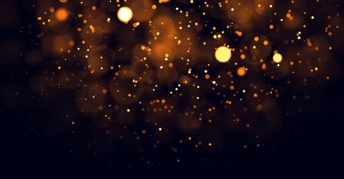 pattern of floating small and large lights in yellow and orange on black background