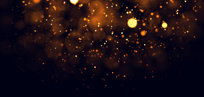 pattern of floating small and large lights in yellow and orange on black background
