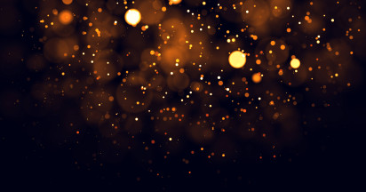 pattern of floating small and large lights in yellow and orange on black background