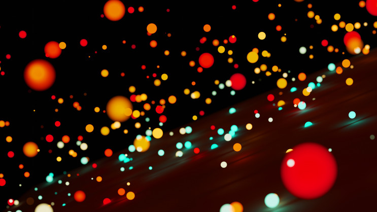 several circle shaped objects in multiple colours on a dark background