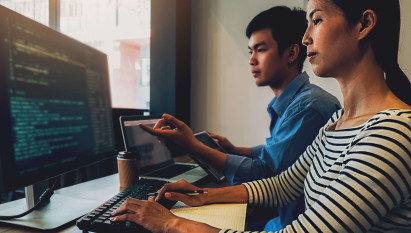 two people working together on computer