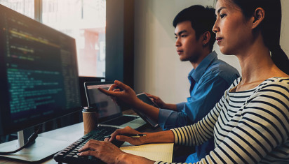 two people working together on computer