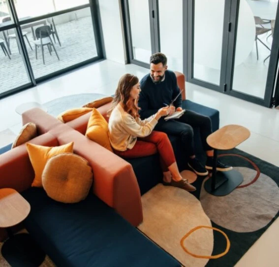 A man and a woman sat on a sofa. 