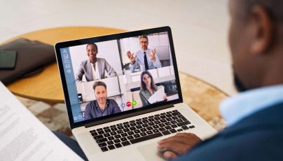 split screen of four people on video call on laptop
