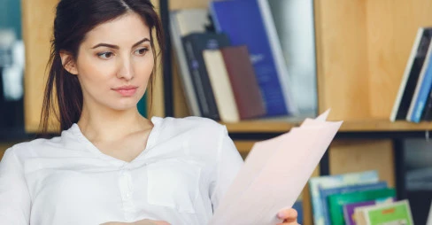 woman sitting reading documents