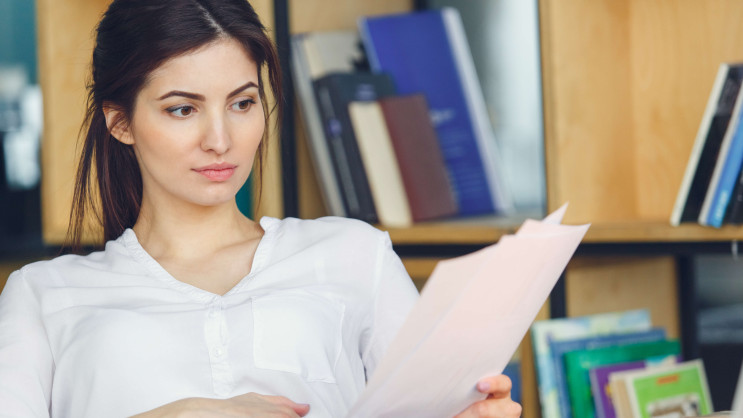 woman sitting reading documents