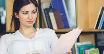 woman sitting reading documents