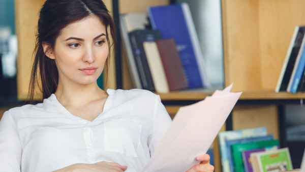 woman sitting reading documents