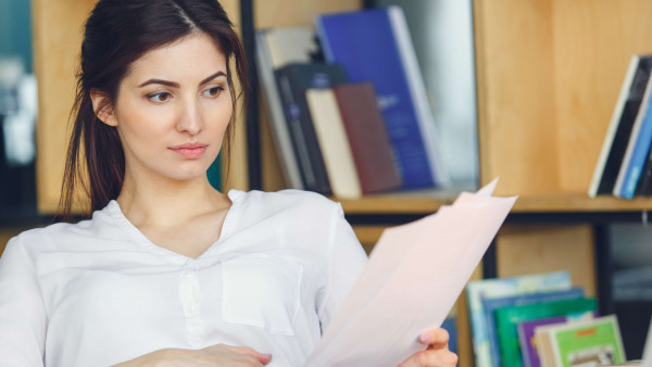 woman sitting reading documents