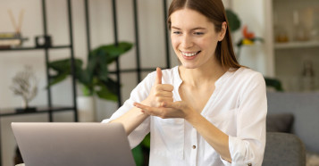 woman sign language in front of laptop