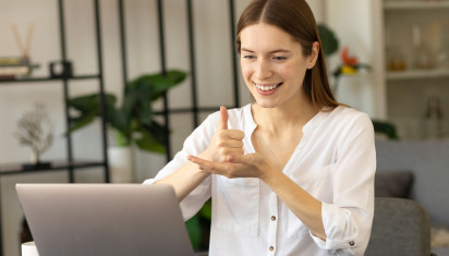 woman sign language in front of laptop